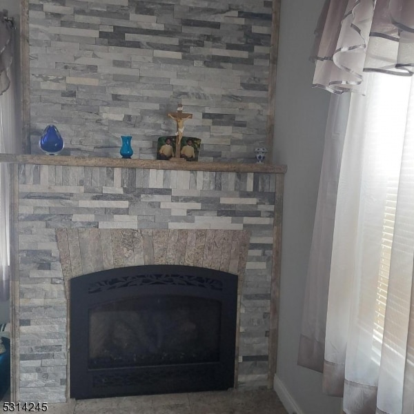 interior details with a stone fireplace