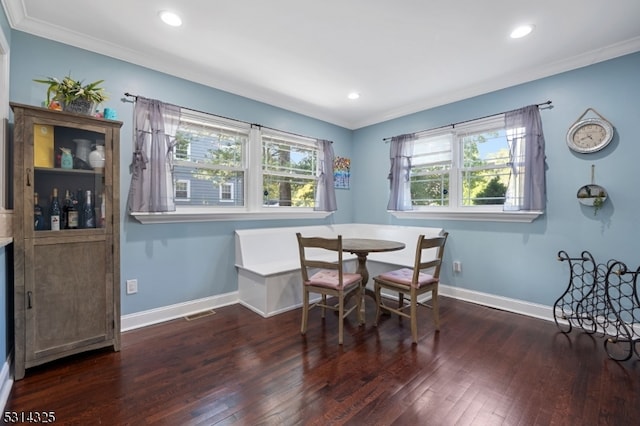 dining room featuring crown molding and dark hardwood / wood-style flooring