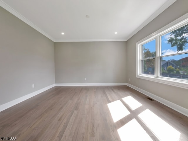 unfurnished room with ornamental molding and light hardwood / wood-style floors