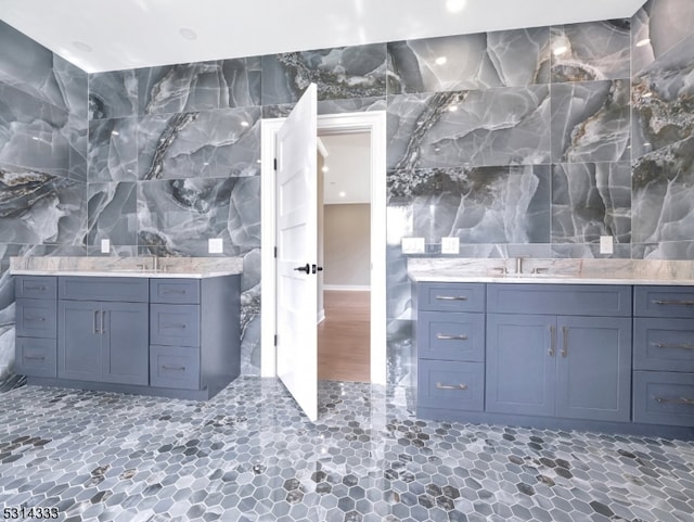 bathroom with vanity and tile walls