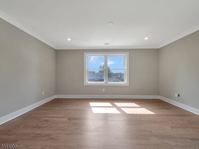 unfurnished room featuring light wood-type flooring and ornamental molding