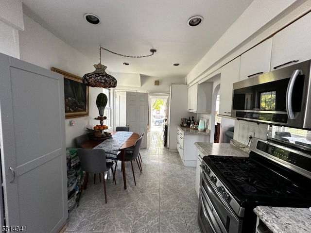 kitchen featuring stainless steel appliances and white cabinetry