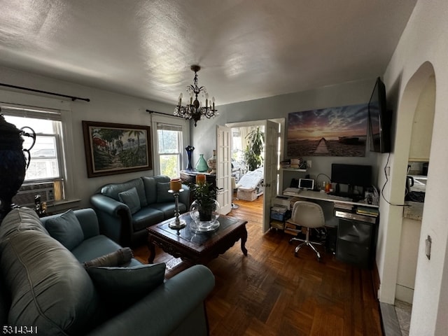 living room with cooling unit and a chandelier