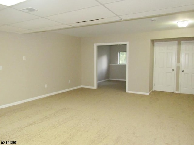 interior space with carpet and a drop ceiling