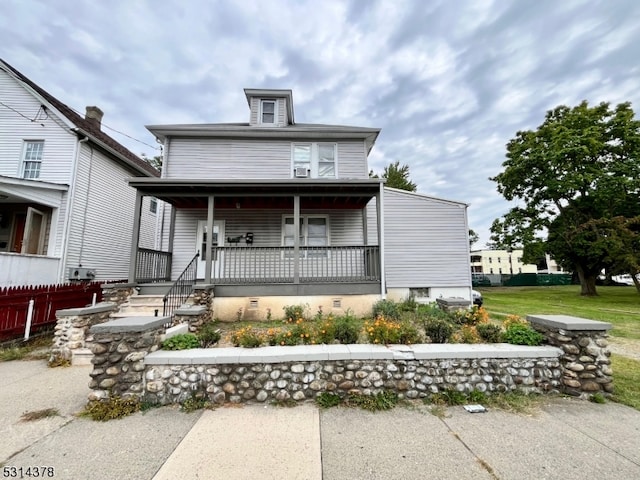 view of front facade with a front yard and covered porch