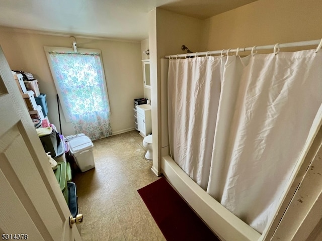 bathroom featuring toilet and a shower with curtain