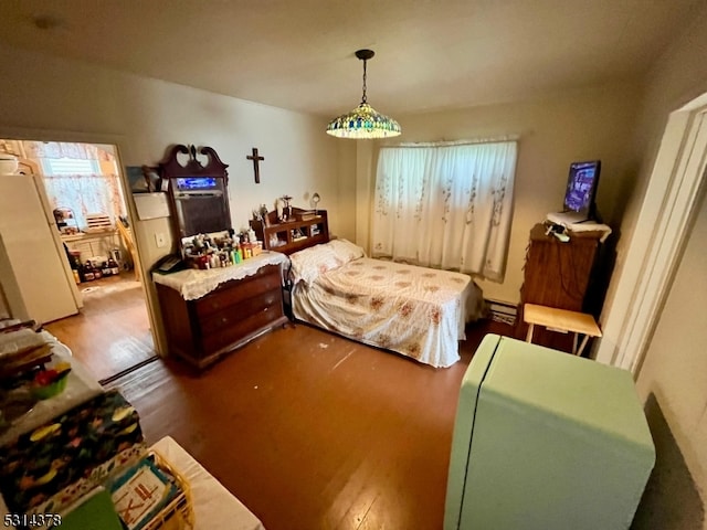 bedroom featuring wood-type flooring and white fridge