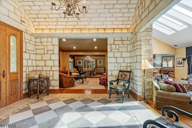 interior space featuring ornamental molding, an inviting chandelier, a skylight, and hardwood / wood-style flooring