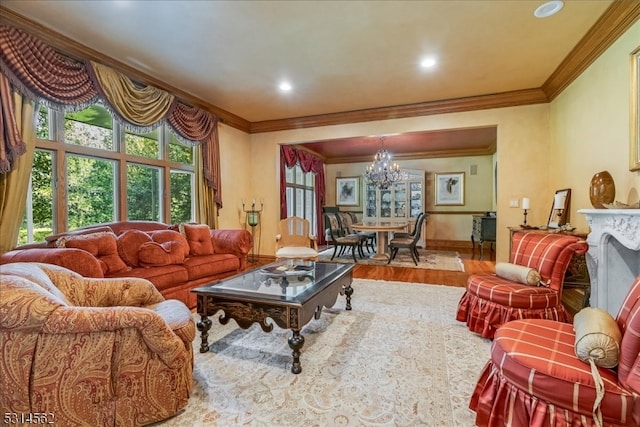 living room with an inviting chandelier, ornamental molding, and hardwood / wood-style flooring