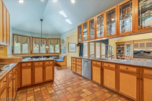 kitchen with pendant lighting, lofted ceiling, sink, stainless steel dishwasher, and light stone countertops