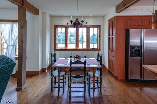 dining room with beam ceiling and wood-type flooring