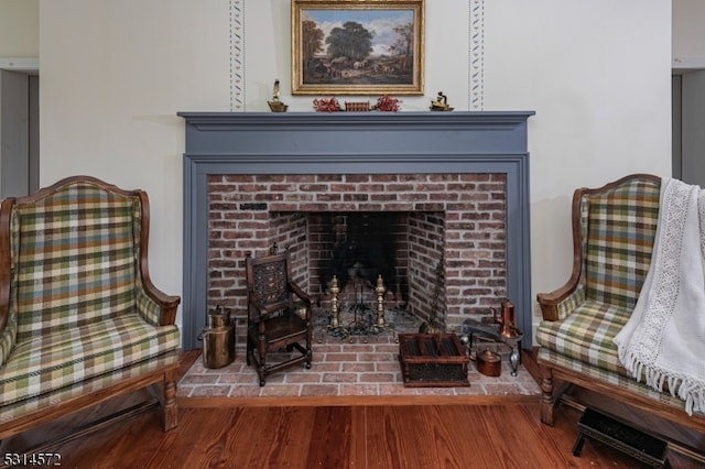 sitting room featuring a fireplace and hardwood / wood-style floors