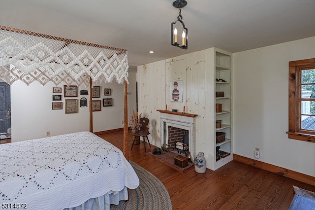 bedroom featuring dark hardwood / wood-style flooring and a chandelier