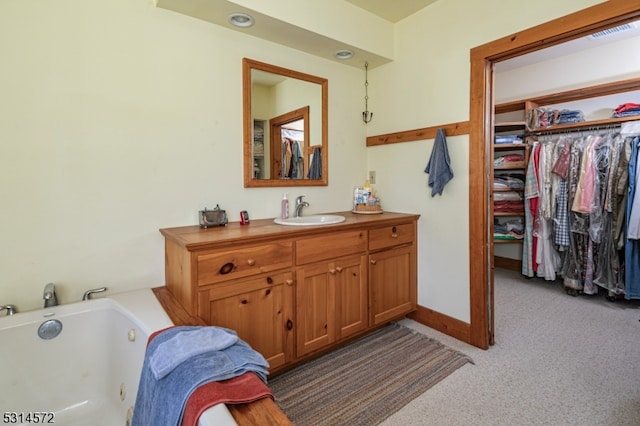 bathroom featuring vanity and a tub