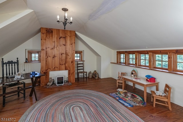 office space with lofted ceiling, a notable chandelier, and hardwood / wood-style flooring