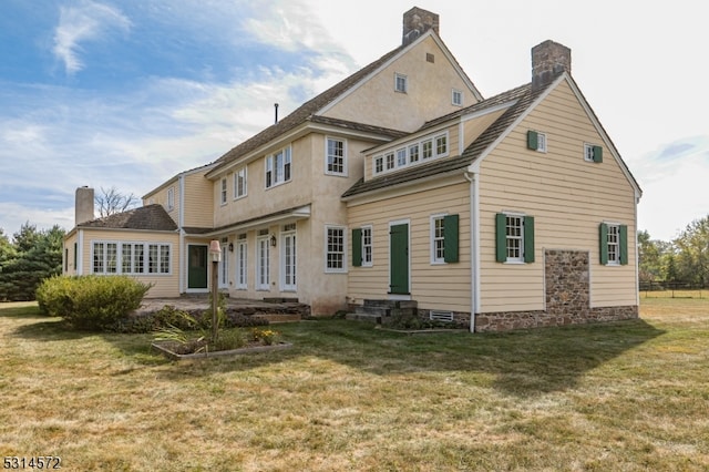 rear view of house with a lawn