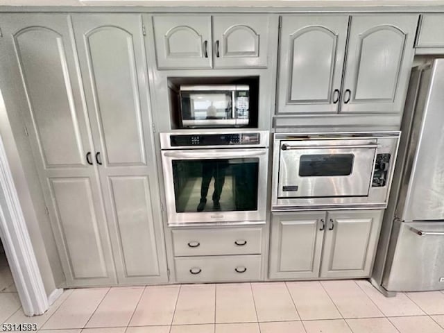 kitchen with light tile patterned floors and appliances with stainless steel finishes