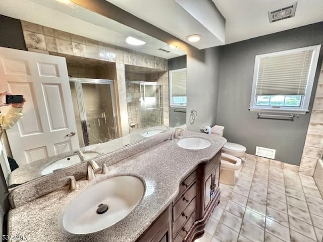 bathroom with an enclosed shower, vanity, a bidet, tile patterned flooring, and toilet