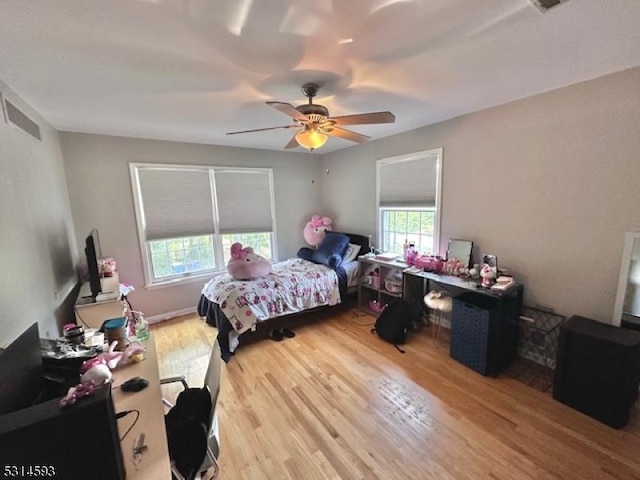 bedroom with hardwood / wood-style floors and ceiling fan