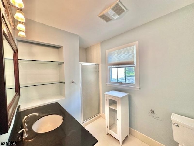 bathroom with vanity, a shower with shower door, and toilet