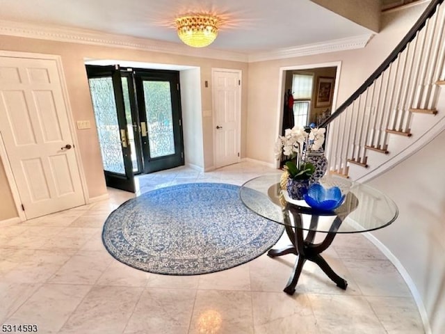 entrance foyer featuring french doors and crown molding