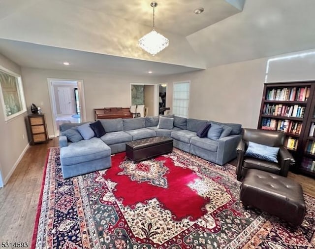 living room featuring hardwood / wood-style floors and vaulted ceiling