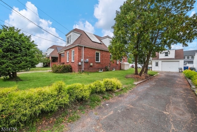 view of front of home with a front yard and a garage