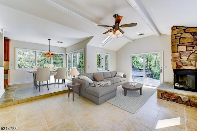 living room featuring light tile patterned floors, vaulted ceiling with beams, ceiling fan, and a fireplace