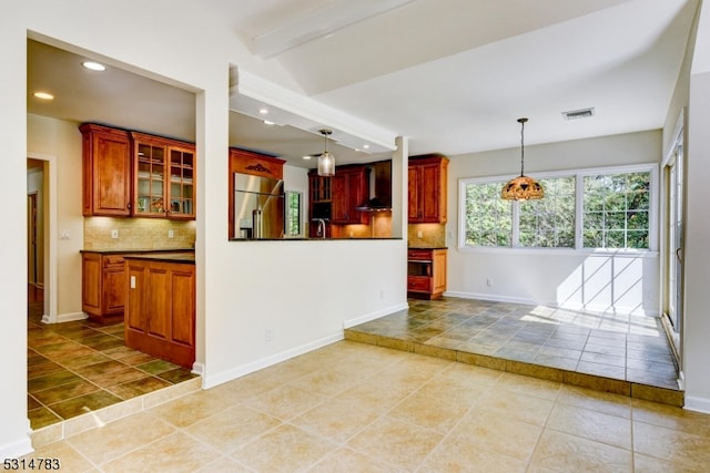 kitchen with high end refrigerator, decorative backsplash, beamed ceiling, and pendant lighting