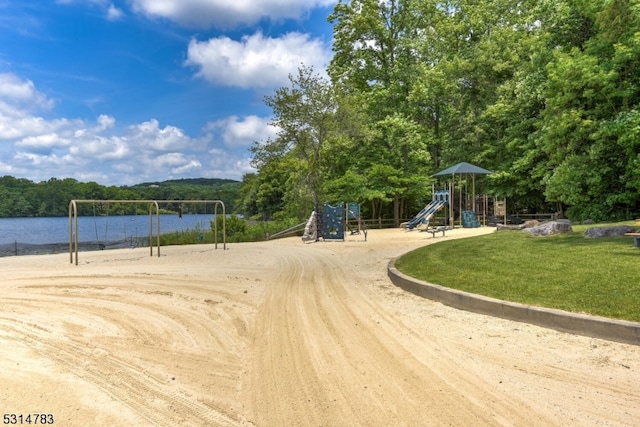 view of home's community with a playground and a water view