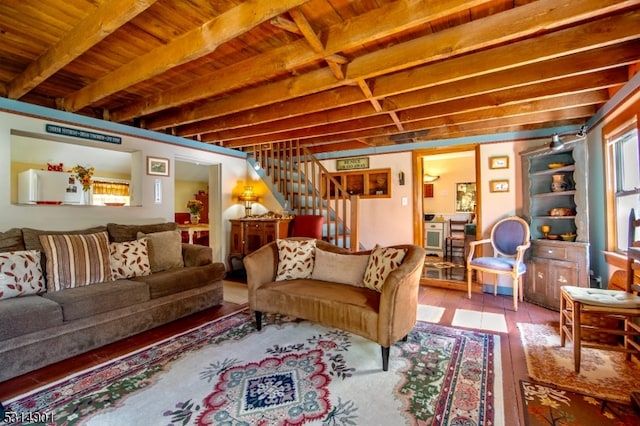 living room featuring wooden ceiling, beamed ceiling, and hardwood / wood-style flooring