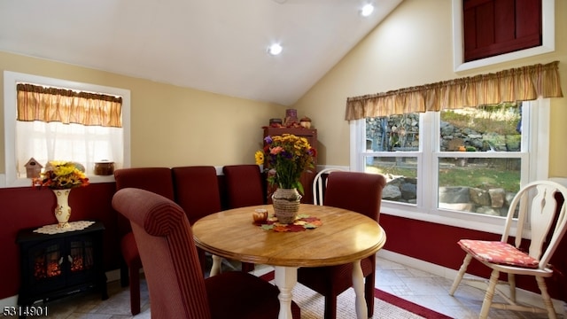 dining room with vaulted ceiling and plenty of natural light