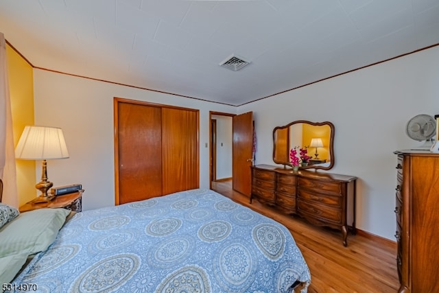 bedroom featuring a closet and light hardwood / wood-style floors