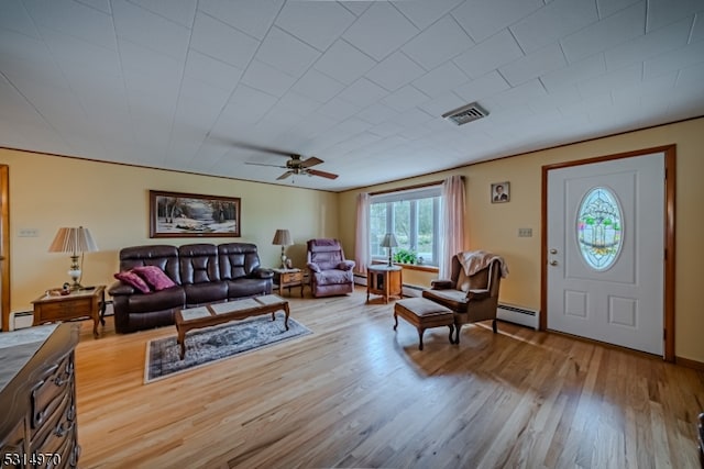 living room with light wood-type flooring, ceiling fan, and baseboard heating