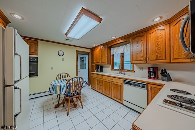 kitchen featuring crown molding, white appliances, sink, and light tile patterned floors