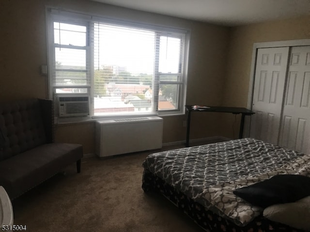 bedroom featuring cooling unit, a closet, carpet flooring, and multiple windows