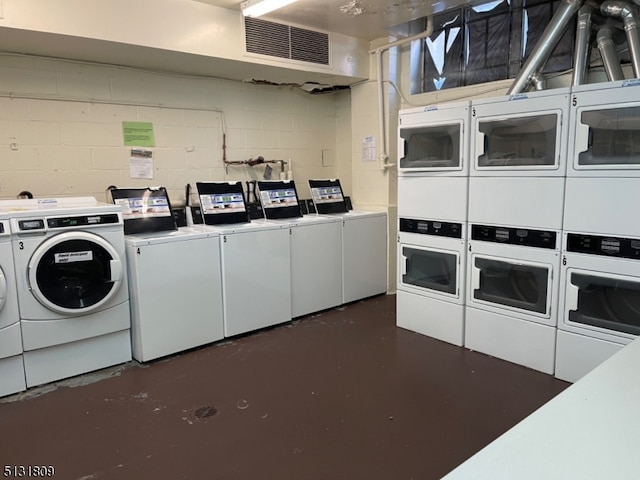 washroom featuring separate washer and dryer and stacked washing maching and dryer