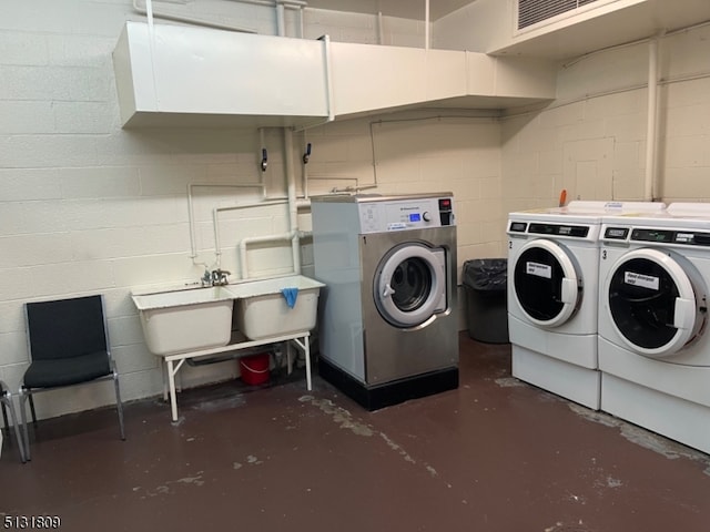 clothes washing area with washing machine and clothes dryer