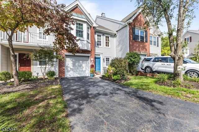 townhome / multi-family property featuring a garage and a balcony