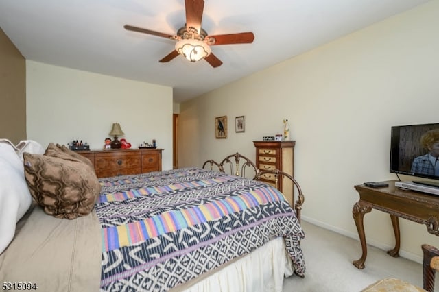 bedroom with ceiling fan and light colored carpet