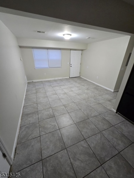 basement featuring tile patterned flooring