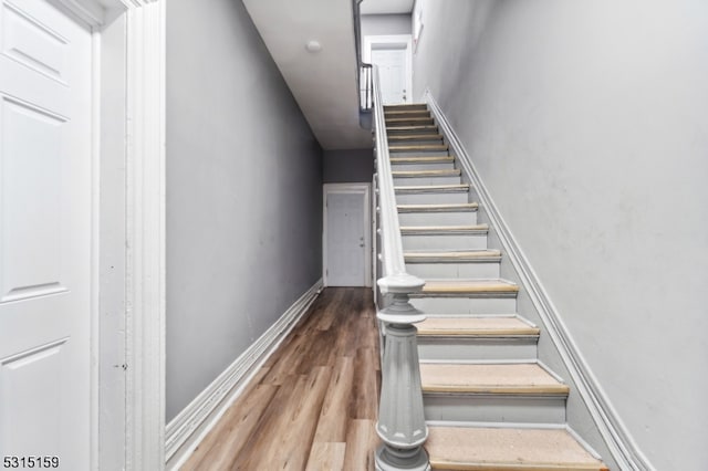 stairs with hardwood / wood-style flooring