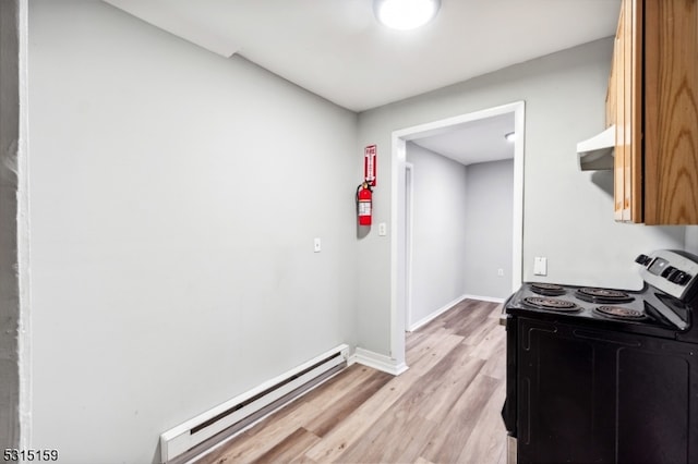 kitchen featuring light hardwood / wood-style flooring, electric range, extractor fan, and a baseboard radiator