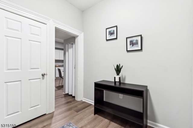 hallway with light hardwood / wood-style floors