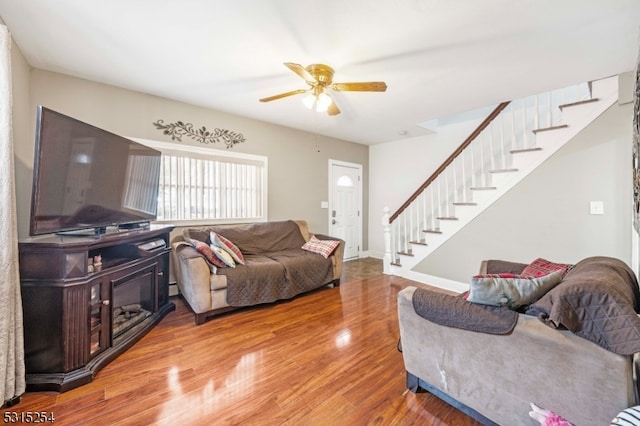 living room with hardwood / wood-style flooring and ceiling fan