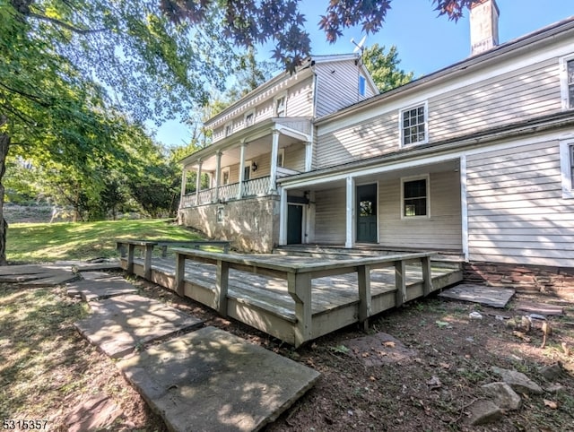 back of property featuring a deck