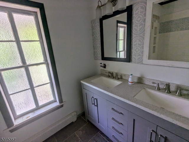 bathroom with vanity, plenty of natural light, and a baseboard heating unit