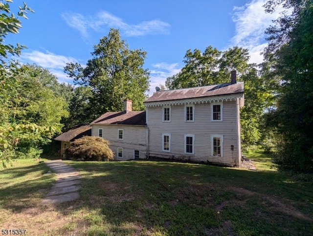 view of side of home with a lawn