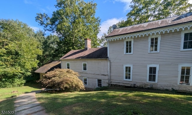 view of side of home featuring a lawn