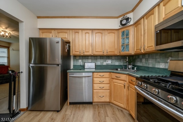 kitchen with appliances with stainless steel finishes, backsplash, ornamental molding, and light hardwood / wood-style flooring